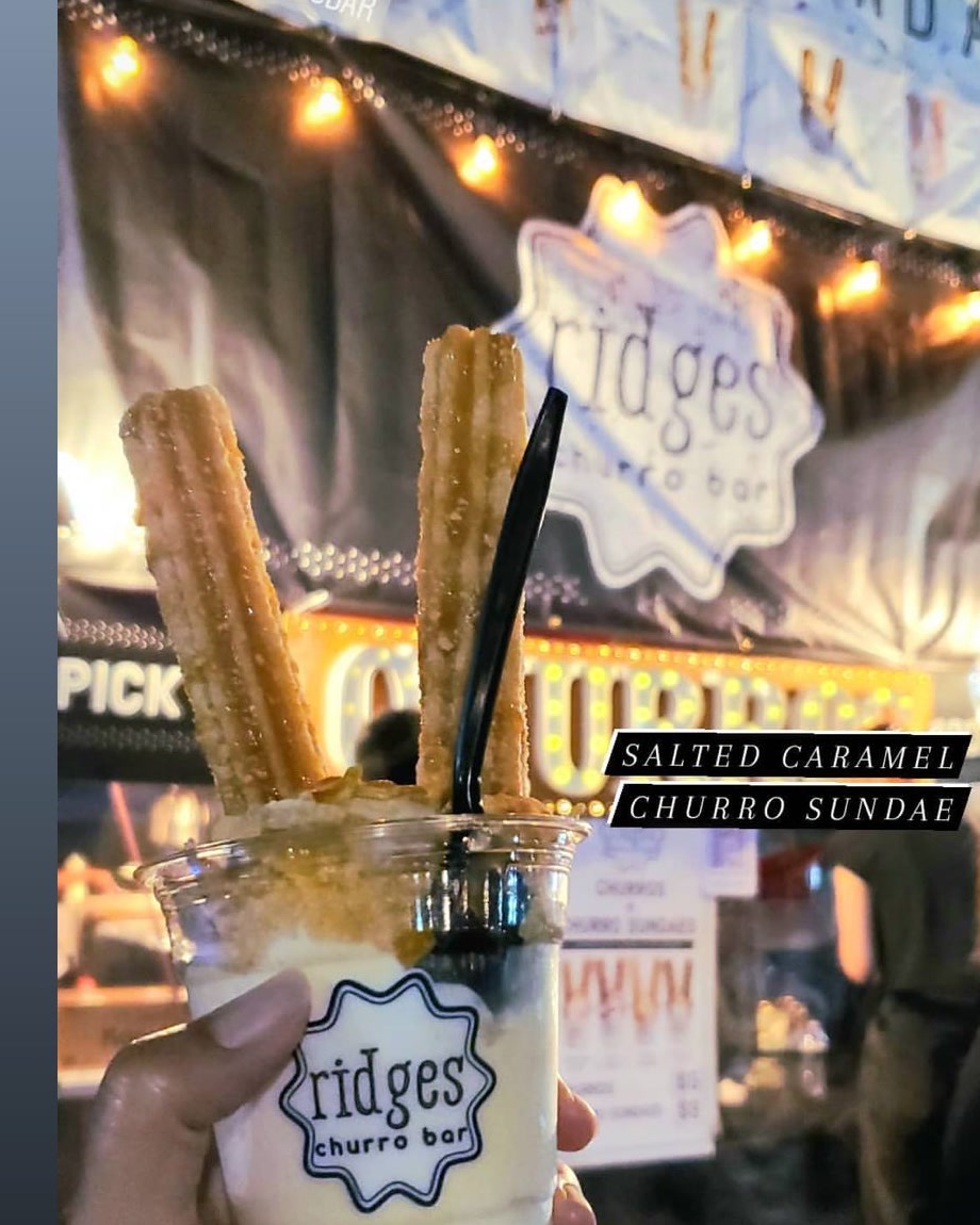 A salted caramel churro sundae in front of the string-lit Ridges booth.